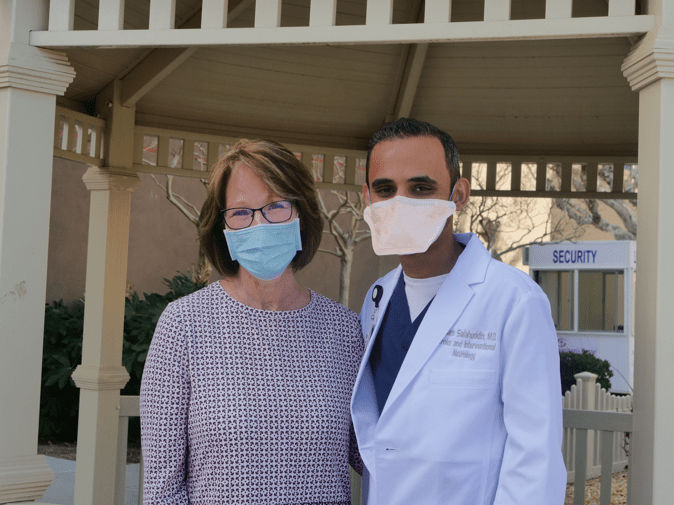 A person and another person wearing face masks
